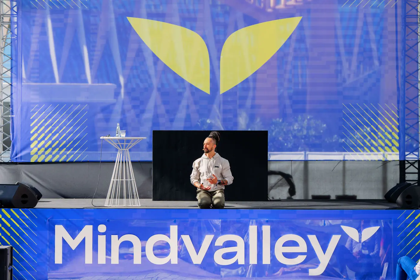 Speaker on stage in front of the Mindvalley screen