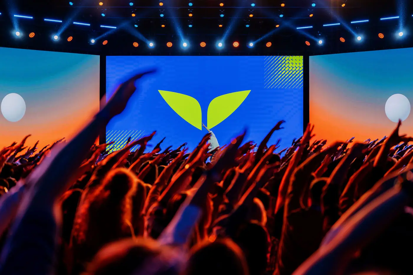 Crowd with hands raised at the stage