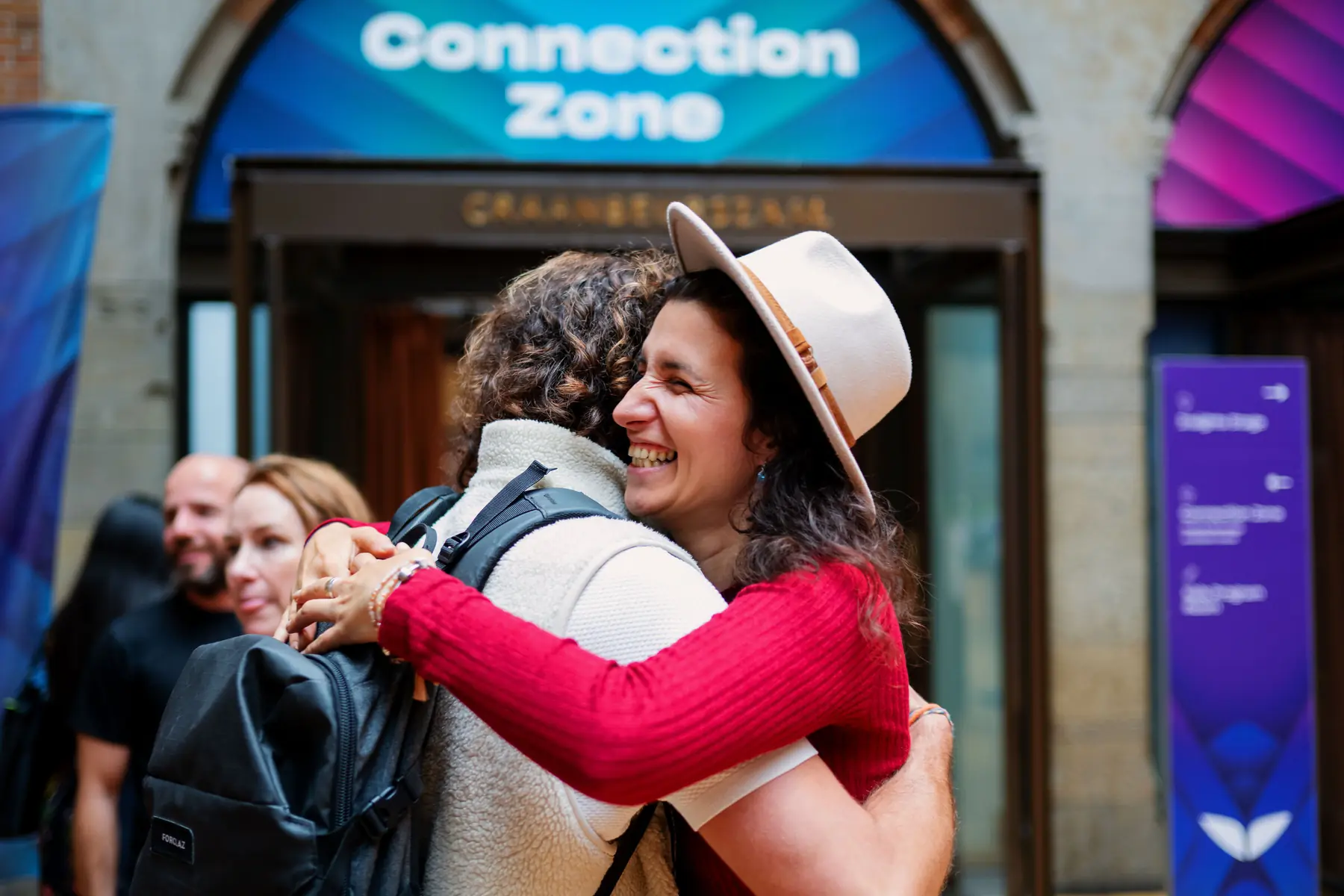 Attendees embracing in the Connection Zone