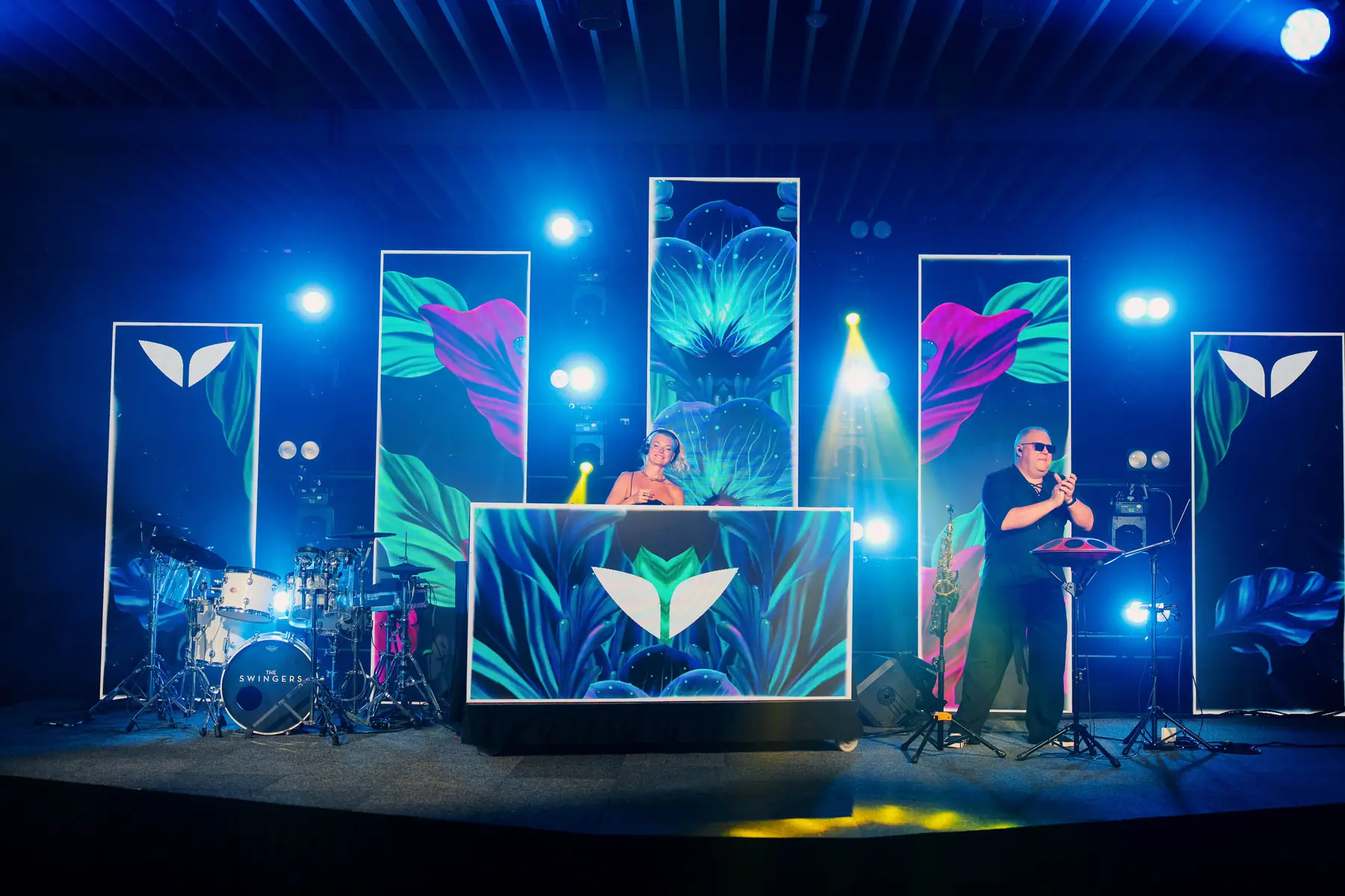 Live band on a stage dressed with Mindvalley U panels
