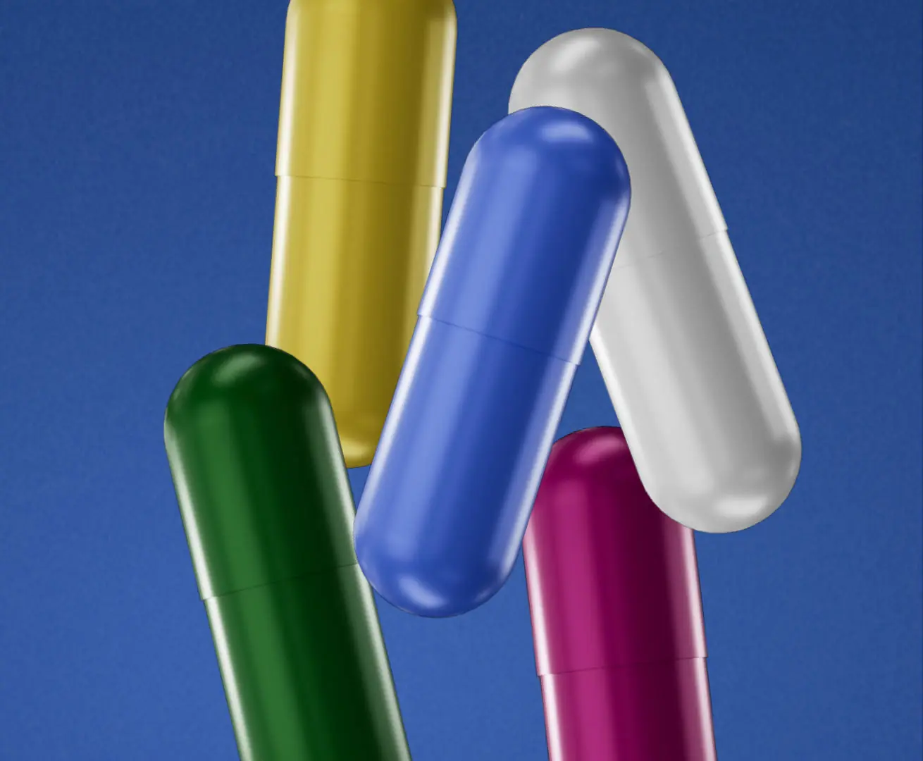 Five coloured capsules on blue
