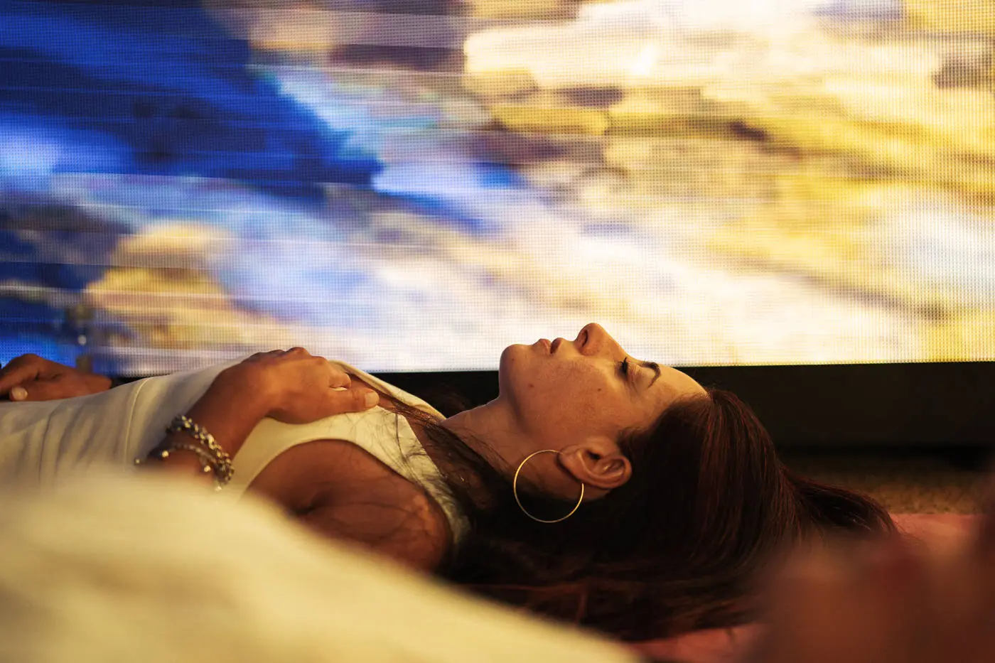 Attendee resting under projected light