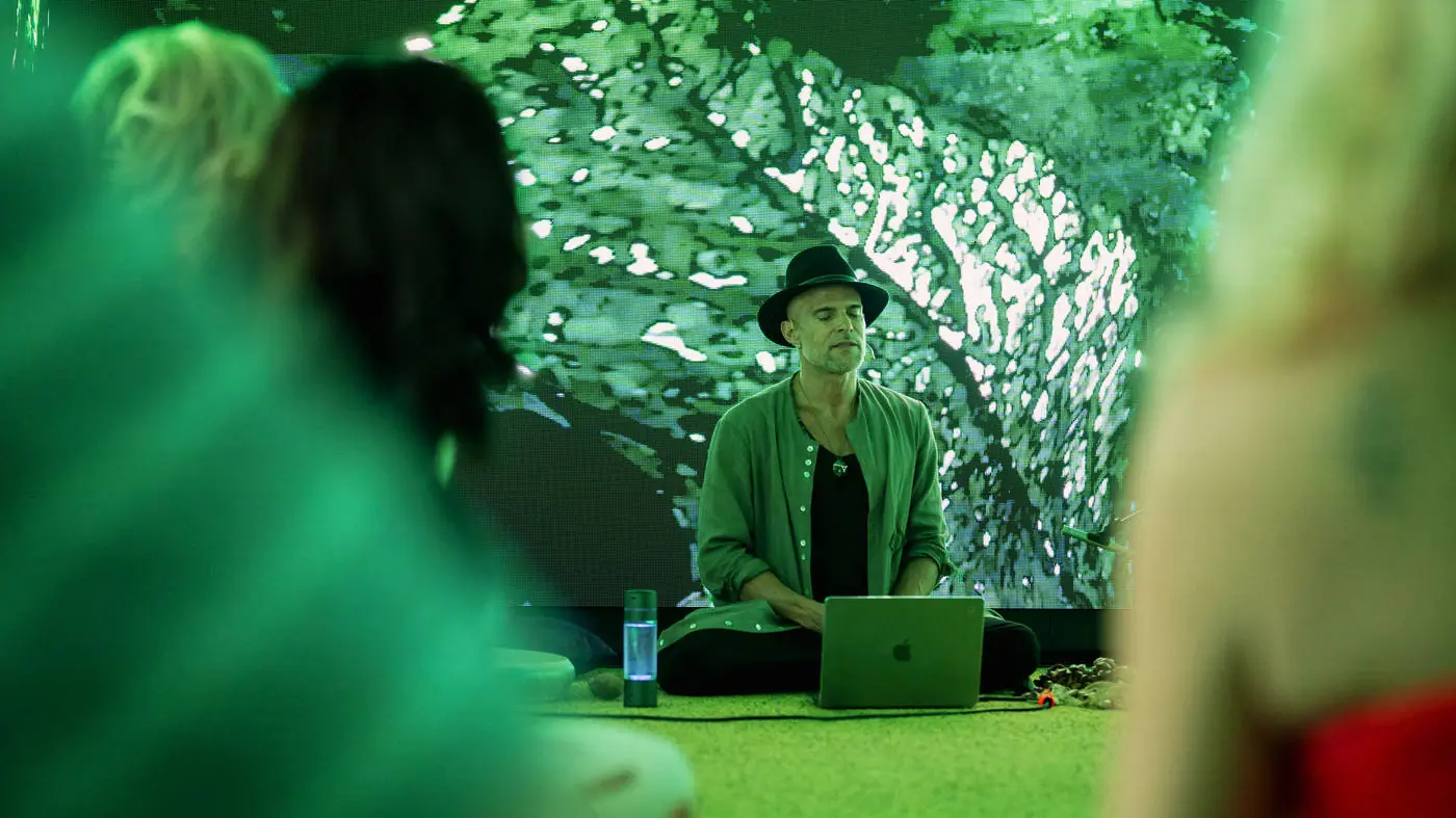Facilitator in a green-lit room